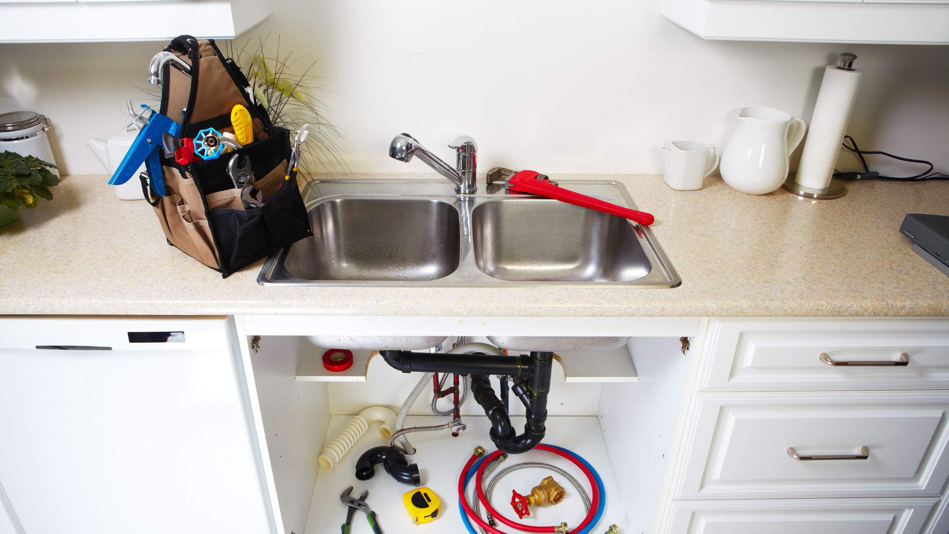 A kitchen sink with a bunch of tools in it